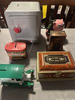 Overview of all six vintage coin banks together on table