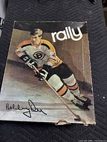 Box front with image of Bobby Orr in Boston Bruins uniform, holding a hockey stick, with Rally branding and printed autograph.