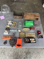 Photo showing various vintage items including Pyrex measuring cup, wooden Borden's cheese box, vintage matchboxes, game pieces, and bicycle light.