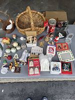 Full lot overview with various vintage and antique Christmas ornaments, holiday collectibles, wicker baskets, and Coca-Cola bank.