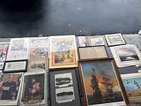 Wide layout of all ephemera and framed items spread on ground showing overall lot contents.