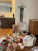 Overview showing green metal tree stand, boxes of ornaments, cards, and Easter items