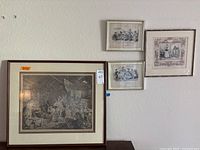 Four framed prints arranged on a wall showing relative sizes and styles