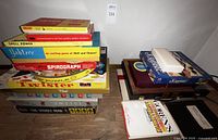 Wide shot of stacked vintage board games and puzzles including Clue, Twister, and The Visible Man