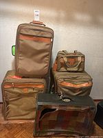 All five pieces of luggage arranged together