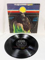 Photo of the vinyl LP record with the cover behind it showing the design and condition of both the vinyl and sleeve.