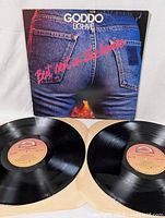 Front cover and two vinyl LPs of 'Best Seat In The House' by Goddo laid out