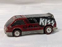 Side view of vintage Hot Wheels KISS Van showing burgundy and black color, KISS logo, and chrome details.