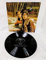 Vinyl LP record and cover by Ian & Sylvia with the record placed in front of the cover showing label details