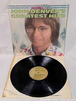 Vinyl record on open cover showing gold RCA Victor label and black disc with no visible scratches.