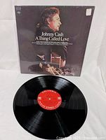 Johnny Cash A Thing Called Love vinyl LP album cover and vinyl disc with Columbia label visible, showing very good vintage condition and intact shrink wrap.