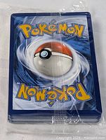 Stack of sealed Pokémon cards showing classic blue backs with Poké Ball design.