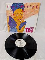 Photo showing the vinyl record placed flat with the Soul Mining cover behind it. The cover has illustrated art of a person smoking.