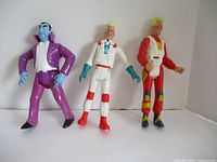 Three Ghostbusters action figures posed standing side by side against a plain background.