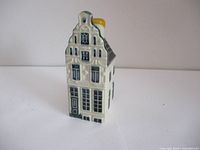 Front and side view showing detailed painted windows, door and architectural style