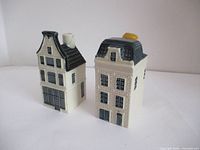 Two KLM ceramic houses facing front showing architectural details and chimneys