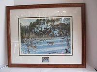 Framed print of wolves in a snowy forest scene by Paul Rankin.