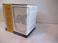Side view of the product box showing a bear illustration on the glass mug with floral designs and captions about the product.
