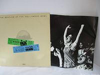 Photo of album cover with two vintage ticket stubs and black-and-white photo insert.