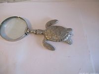 Top view of the turtle-shaped magnifying glass showing the turtle body and magnifying lens