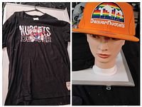 Photo showing the black Denver Nuggets throwback T-shirt with graphic and the orange Denver Nuggets hat on a mannequin head.