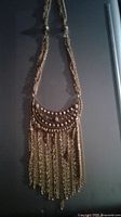 Goldette Etruscan style gold tone necklace with fringe pendant, shown hanging.