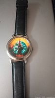 Front view of the vintage Highlander MacLeod men's wristwatch, showing colorful dial design and black leather band.