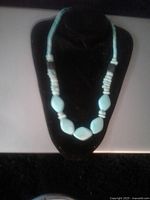 Front view of vintage turquoise necklace on display bust.