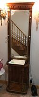 Full view of wood hall stand showing large etched mirror, marble top, and clothes hooks