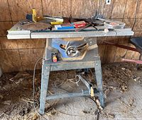 Front view of Mastercraft Hawkeye laser table saw with tools and blades laid out on top, showing general condition and setup.