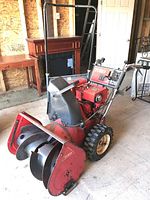 Side view of Toro 826 snowblower and shovel leaning behind