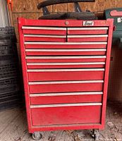 Front view of the red Beach tool chest with nine drawers showing wear and no key in lock.