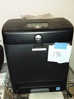 Front view of the Dell 3130cn printer showing its black body, paper output slot, and Dell logo.