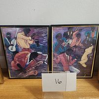 Two framed jazz band prints side by side on a wooden surface, showing the full artwork and frames with a label '16' in front.