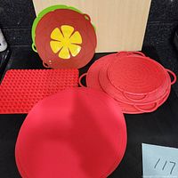 Overview of silicone kitchen items including red baking mat, textured mat, round splatter guards, and flower design pot lids in red and green.