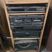 Full view of cabinet with stacked Technics stereo components: 5 disc CD player, dual cassette deck, equalizer, amplifier, and turntable at the bottom.