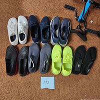 Nine pairs of women's casual comfort shoes, size 10, arranged on a carpeted floor.