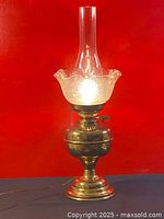 Full view of brass oil lamp converted to electric with glass etched shade and tall chimney, showing overall condition and patina.