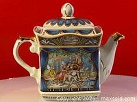 Front view of James Sadler teapot showing theatrical scene with seated figures and blue curtains, gold accents on handle and lid, marked 'WILLIAM SHAKESPEARE 1564-1616'
