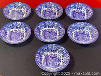 Top view showing the seven blue and white Dickens ironstone bowls arranged in a group, highlighting the detailed scenic patterns inside each bowl.