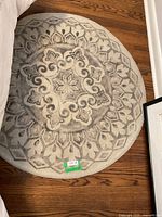 Full view of the 48 inch diameter round area mat rug placed on wooden floor, showing overall shape and design.