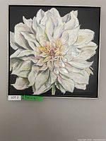 Frontal view of the framed white flower canvas painting with textured petals and dark background.