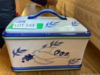 Front view of covered ceramic box showing blue bird and leaf design with LOT 544 label on top lid.