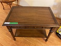 Front top view of the rectangular wooden occasional table showing smooth top and carved apron detail.