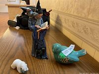 All figurines on wooden surface showing wizard, bird, and polar bear.