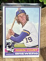 Front view of the 1976 Topps Robin Yount #316 card in protective sleeve, displaying the player in batting stance with Brewers logo and colors.