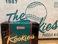 Photo of sealed box of 1987 Donruss The Rookies with black and green pattern and gold 'The Rookies' lettering.