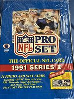 Front view of the sealed 1991 NFL Pro Set Series 1 hobby box showing blue and red design with photos of NFL players and product branding.