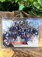 Front view of the Jose Bautista 2015 Topps Holiday Parallel card in protective casing showing the bat flip moment and snowflake motif.