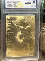 Front side of 1997 Skybox Z Force Michael Jordan gold trading card graded 10 by WCG. Shows embossed Michael Jordan mid-air with Chicago Bulls logo and name in gold.